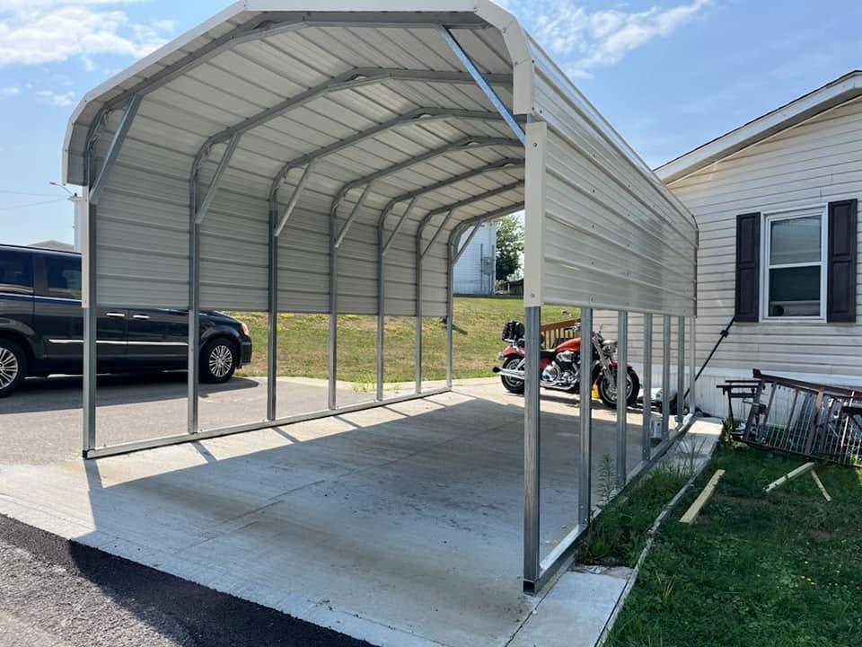 Open metal carport on a concrete pad